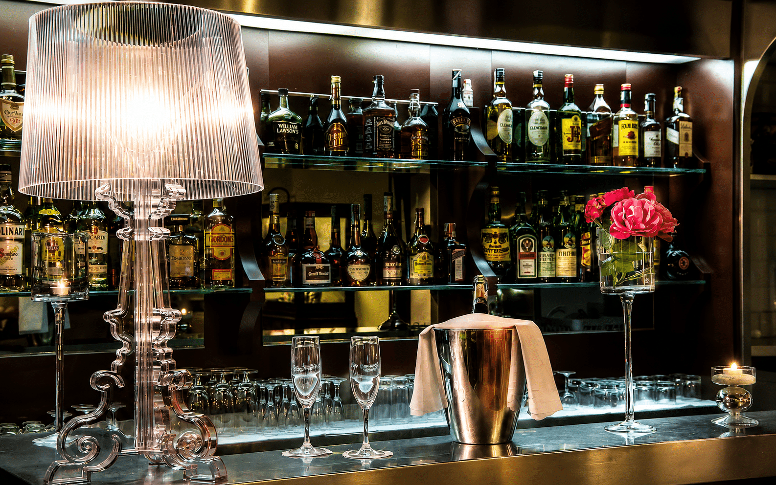 Lamp and bottles on an elegant bar counter.