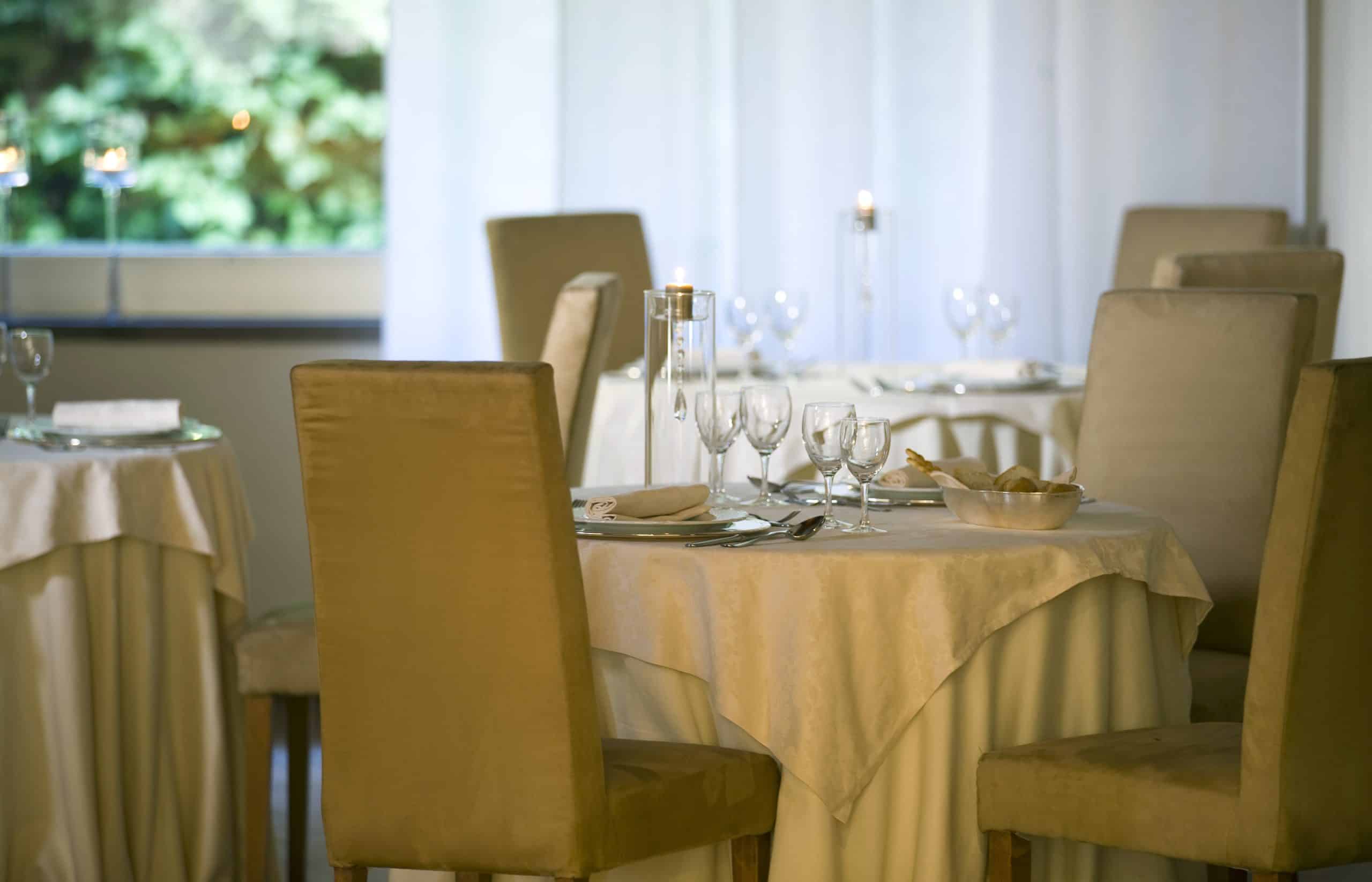 Tables set in an elegant restaurant.