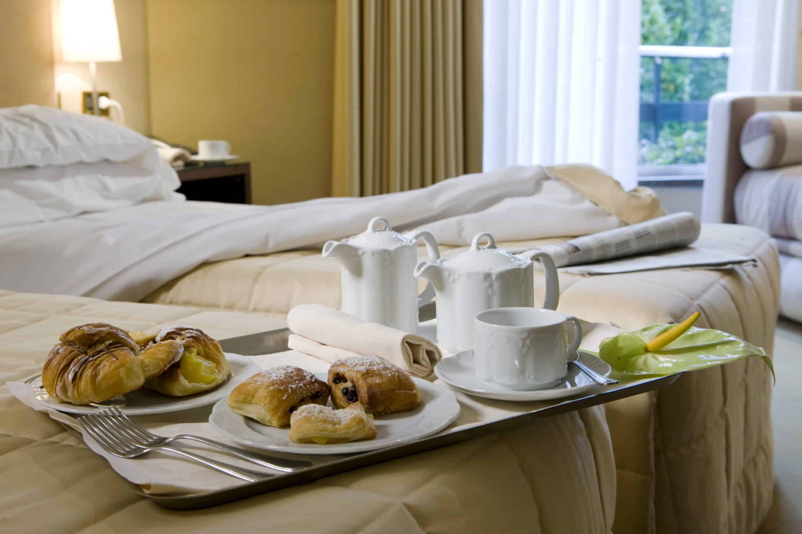 Breakfast in bed with croissants and coffee.